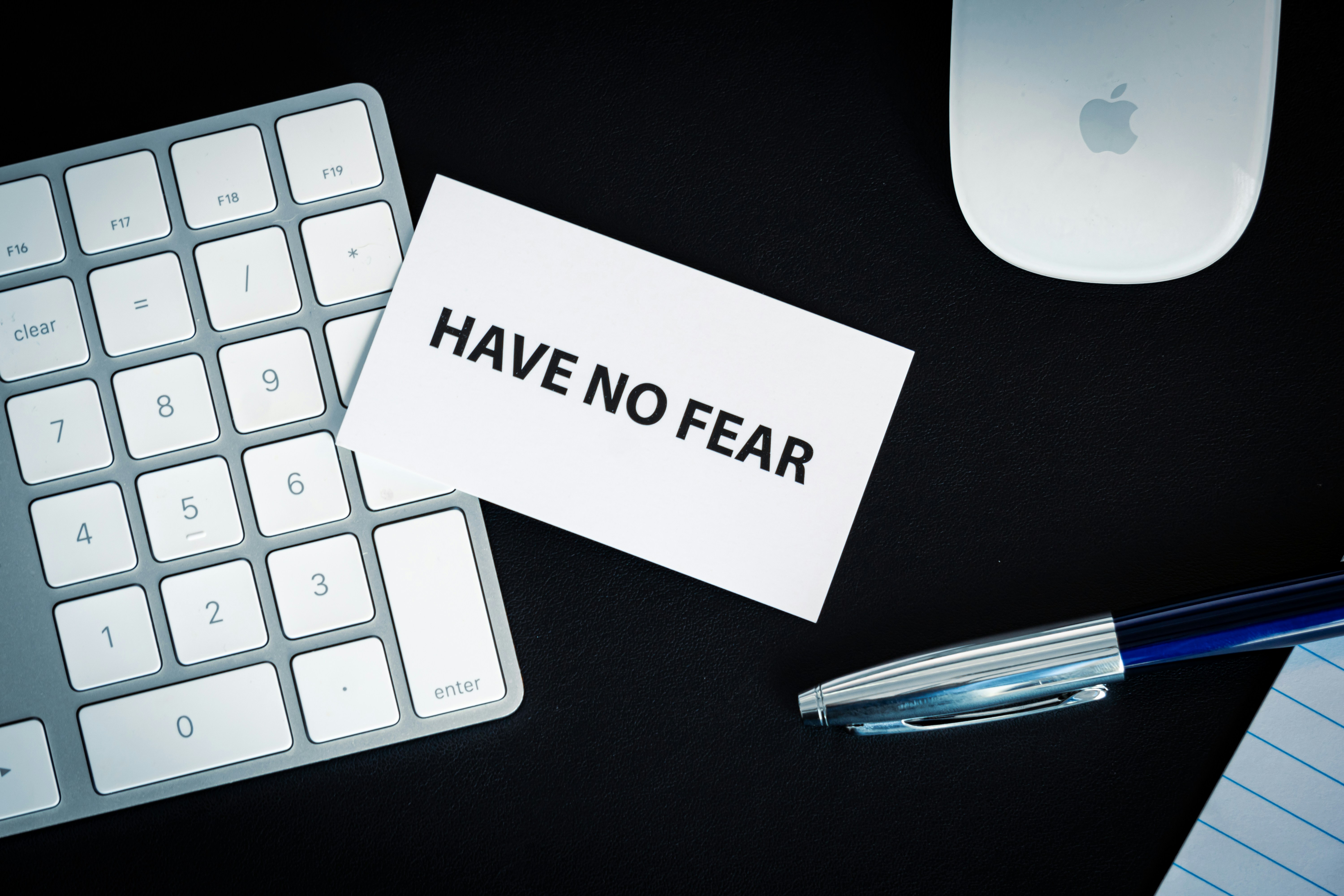 Card saying 'Have no fear' laid across a numerical keypad